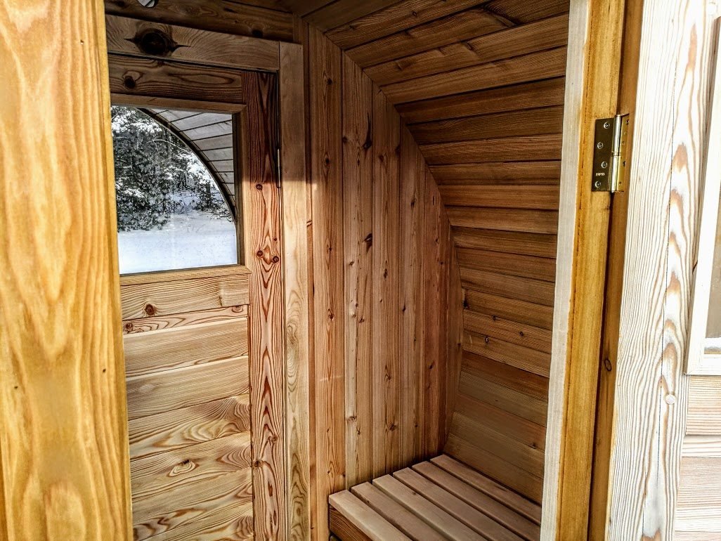 Outdoor barrel sauna with changing room